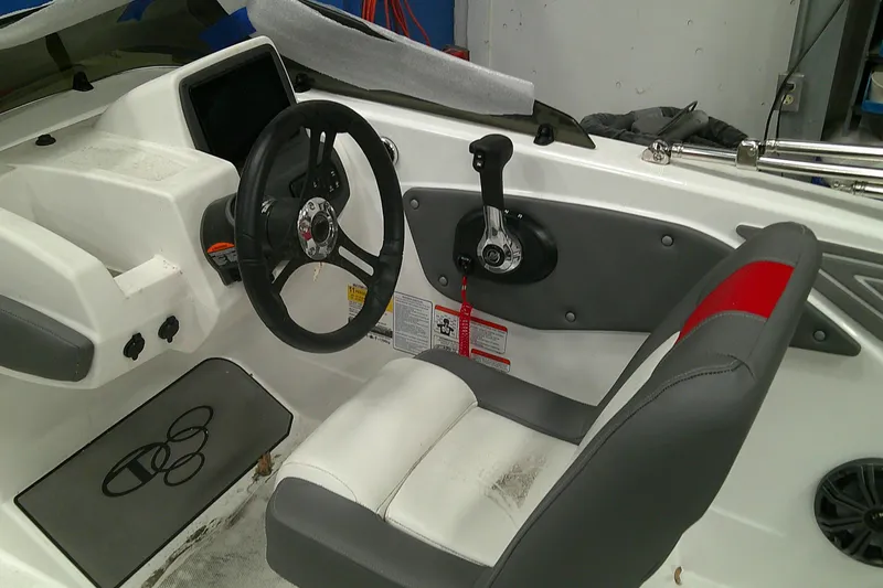 Slide: The Image of Interior of 2025 Tahoe T21 boat featuring steering wheel and control panel. - 7