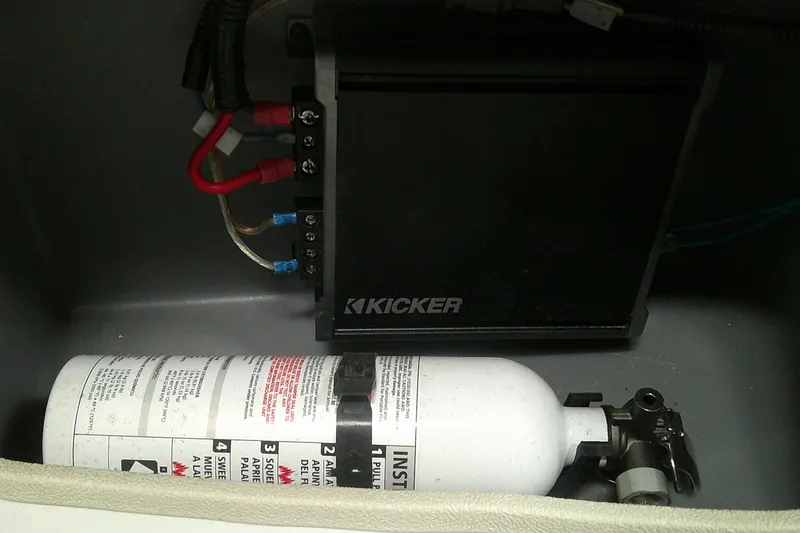 Slide: The Image of Kicker amplifier and fire extinguisher in 2025 Tahoe T21 vehicle compartment. - 9