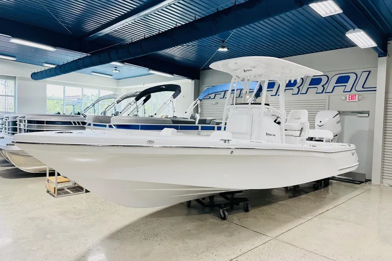 The Image of 2026 BlackJack 256 Coastal boat displayed in a showroom with blue ceiling. - 1