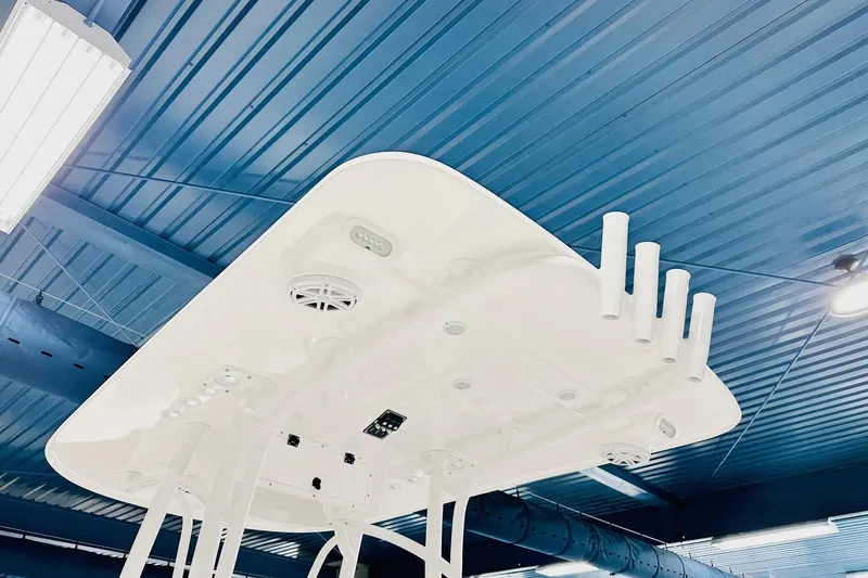 Slide: The Image of 2026 BlackJack 256 Coastal boat top view in a blue-roofed showroom. - 4