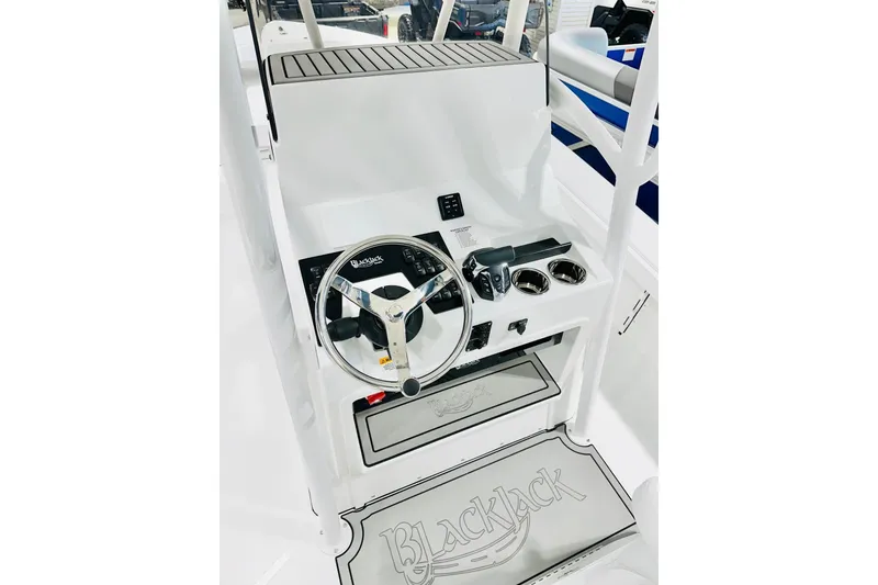 Slide: The Image of 2026 BlackJack 256 Coastal boat console with steering wheel and controls. - 5