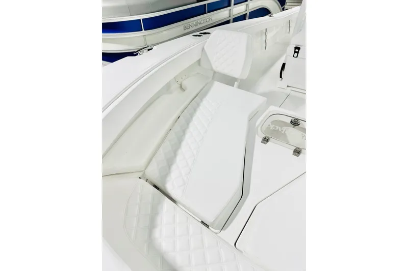 Slide: The Image of 2026 BlackJack 256 Coastal boat interior with white cushioned seating and storage compartments. - 8