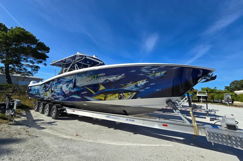 The Image of 2013 Invincible 42 Open Fisherman boat with vibrant marine artwork on trailer. - 1
