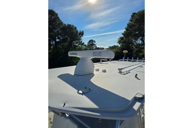 Slide: The Image of 2013 Invincible 42 Open Fisherman with Garmin xHD2 radar on roof under clear sky. - 12
