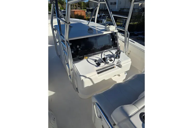 Slide: The Image of 2013 Invincible 42 Open Fisherman boat console with steering wheel and navigation equipment. - 16
