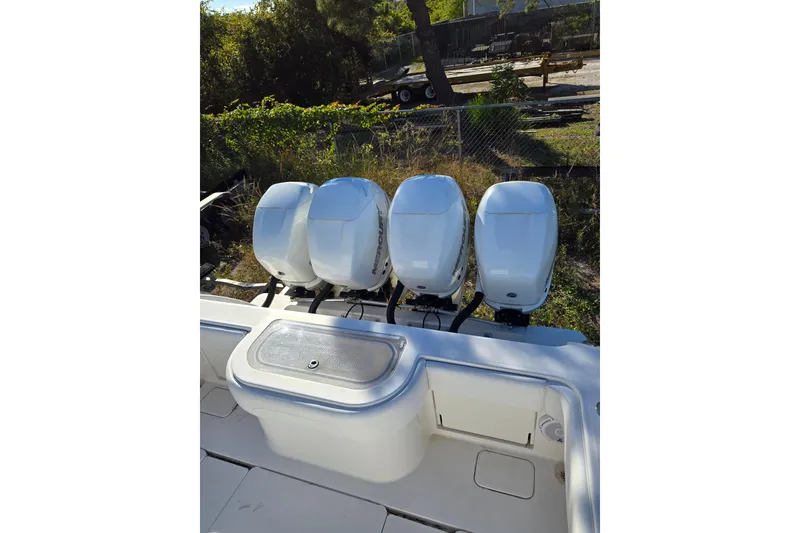 Slide: The Image of Four powerful outboard engines on a 2013 Invincible 42 Open Fisherman boat. - 17