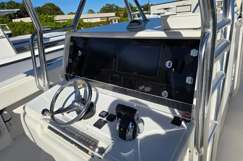 Slide: The Image of 2013 Invincible 42 Open Fisherman boat console with steering wheel and controls. - 8