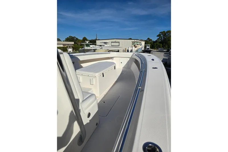 Slide: The Image of 2013 Invincible 42 Open Fisherman boat, spacious deck, sleek design, outdoor setting. - 9