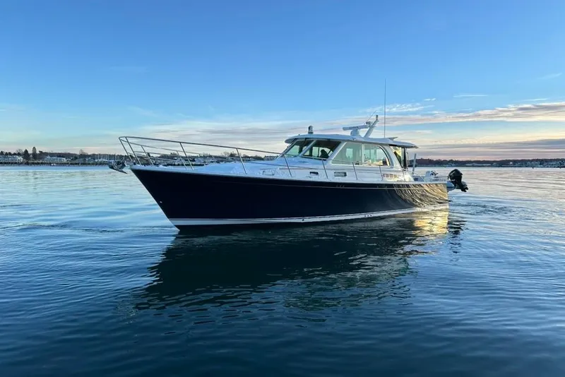 Slide: The Image of 2020 Sabre 45 Salon Express yacht on calm water at sunset. - 16