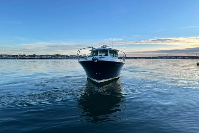 Slide: The Image of 2020 Sabre 45 Salon Express yacht on calm water at sunset. - 21