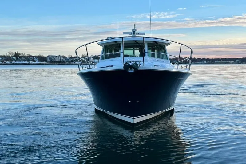 Slide: The Image of 2020 Sabre 45 Salon Express yacht on calm water at sunset. - 22