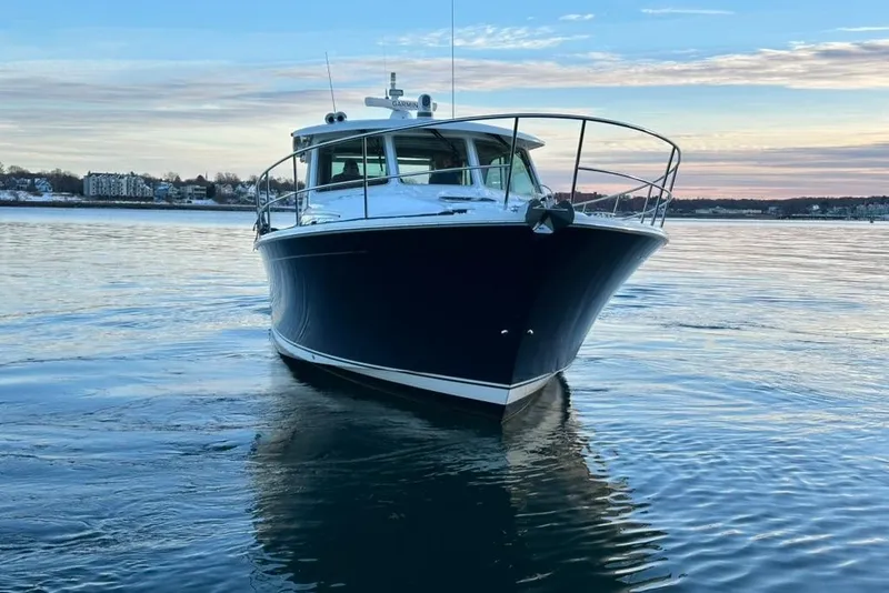 Slide: The Image of 2020 Sabre 45 Salon Express yacht on calm water at sunset. - 23