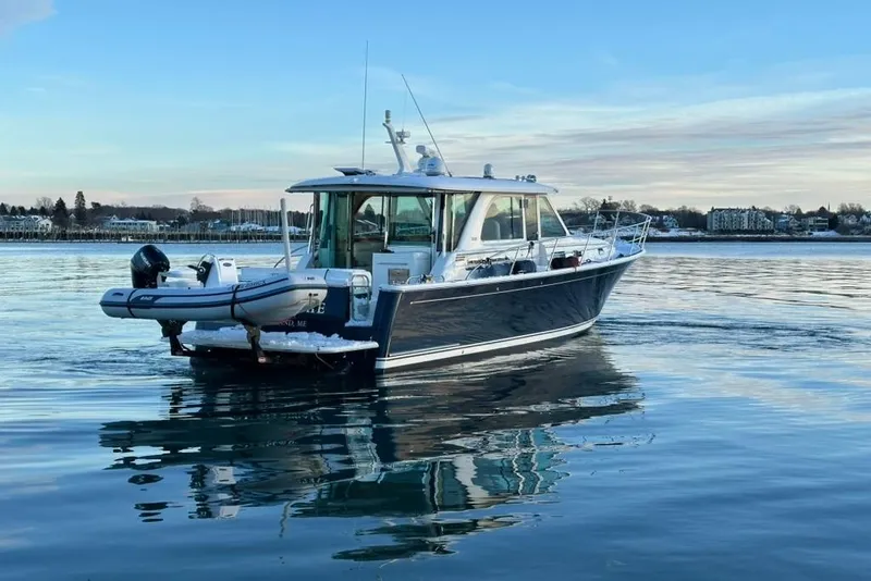 Slide: The Image of 2020 Sabre 45 Salon Express yacht on calm water, scenic background. - 3