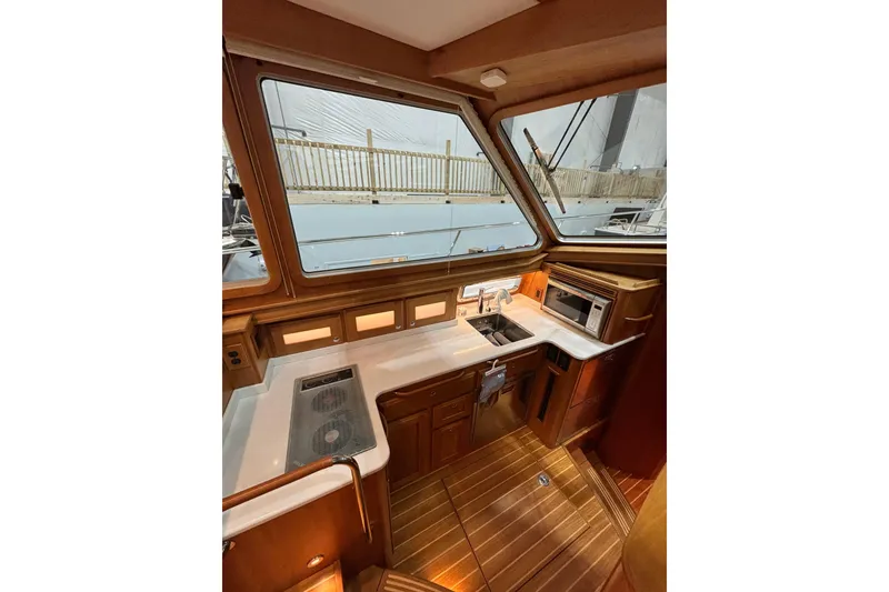 Slide: The Image of Interior of 2020 Sabre 45 Salon Express yacht kitchen with wood finish and modern appliances. - 36