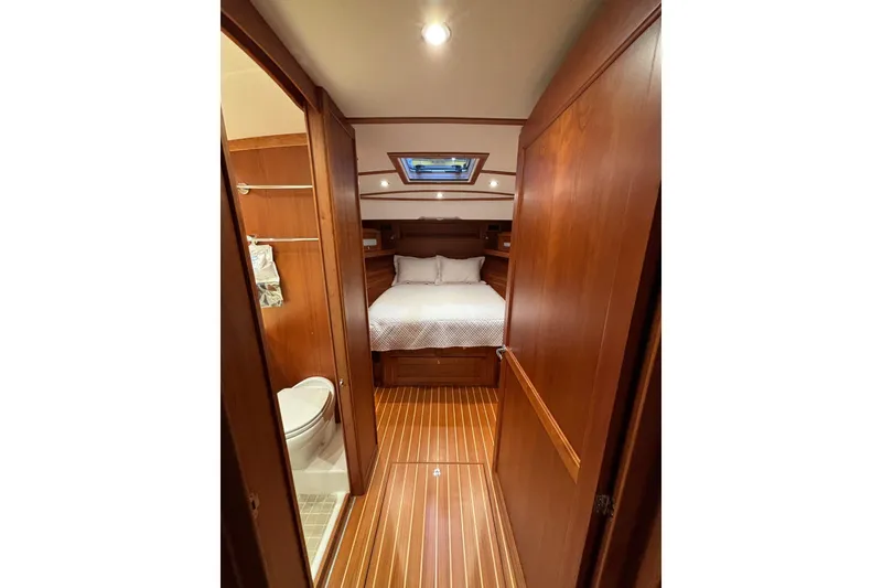 Slide: The Image of Luxurious cabin interior of 2020 Sabre 45 Salon Express yacht, featuring wood finishes and cozy bedding. - 41