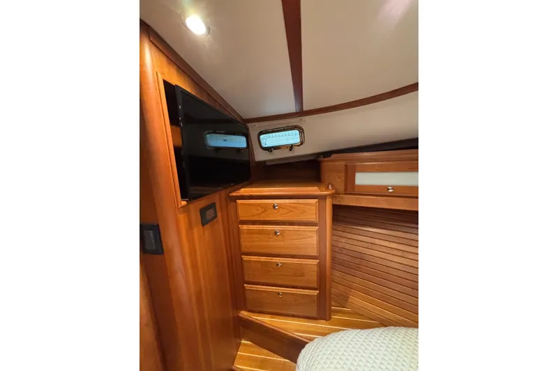 Slide: The Image of 2020 Sabre 45 Salon Express interior with wooden cabinetry and mounted TV. - 46