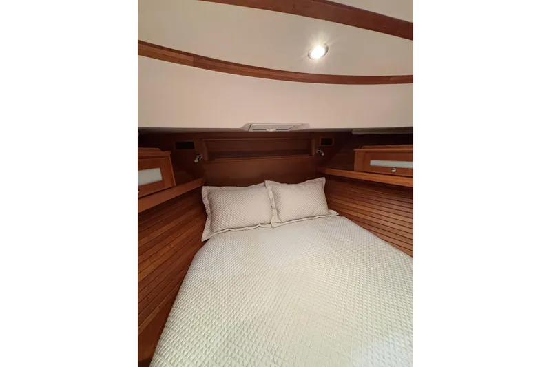 Slide: The Image of 2020 Sabre 45 Salon Express cabin with cozy bed and wooden interior. - 48