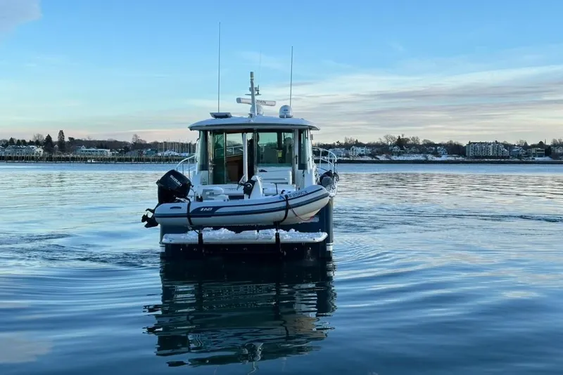 Slide: The Image of 2020 Sabre 45 Salon Express boat on calm water with scenic shoreline background. - 5