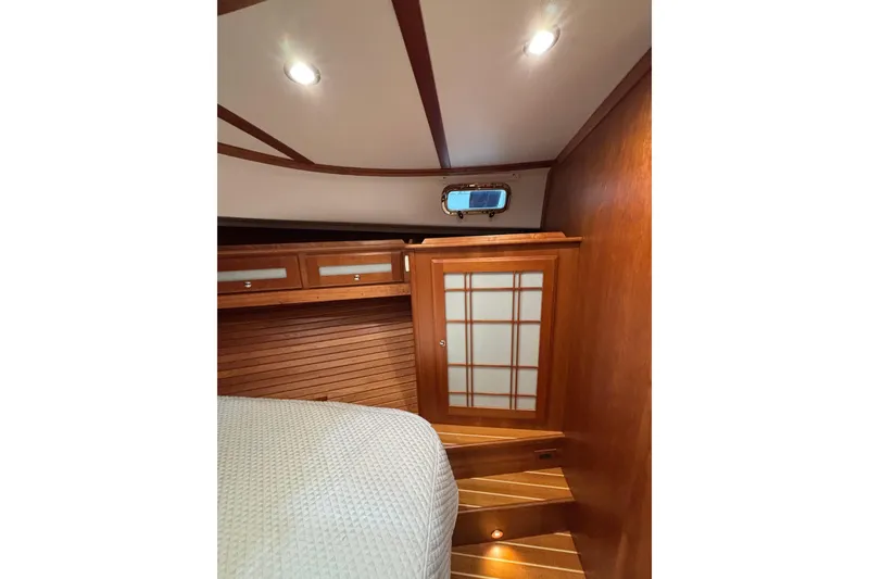 Slide: The Image of Interior of 2020 Sabre 45 Salon Express, featuring wooden cabinetry and cozy lighting. - 50