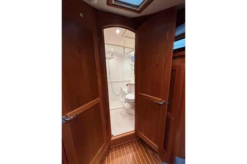Slide: The Image of 2020 Sabre 45 Salon Express bathroom with wooden doors and modern fixtures. - 54