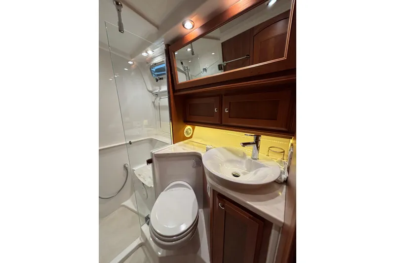 Slide: The Image of Luxurious bathroom in 2020 Sabre 45 Salon Express yacht with modern fixtures and wood cabinetry. - 56