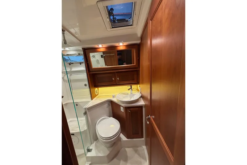 Slide: The Image of Luxurious bathroom in 2020 Sabre 45 Salon Express yacht with wood cabinetry and modern fixtures. - 59