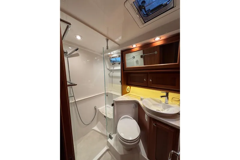 Slide: The Image of Luxurious bathroom in 2020 Sabre 45 Salon Express yacht with modern fixtures and wood accents. - 60