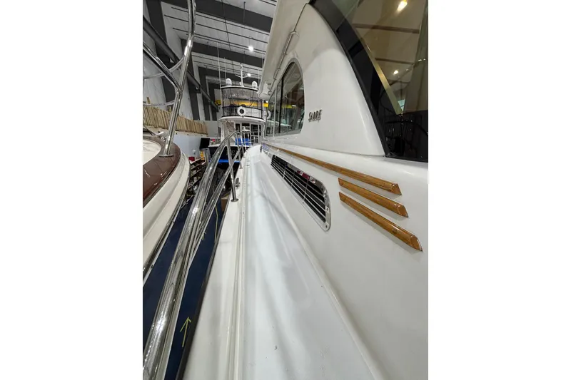 Slide: The Image of 2020 Sabre 45 Salon Express yacht in showroom, showcasing sleek design and polished railings. - 63