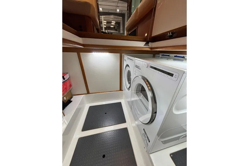 Slide: The Image of Laundry area in 2020 Sabre 45 Salon Express yacht with washer and dryer. - 69