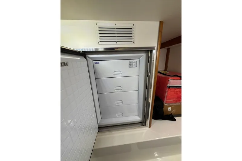 Slide: The Image of Freezer drawers inside 2020 Sabre 45 Salon Express yacht, showcasing storage space. - 71