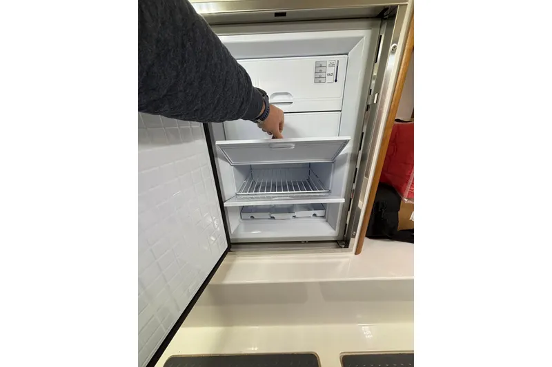 Slide: The Image of Interior view of a 2020 Sabre 45 Salon Express refrigerator with open drawers. - 72
