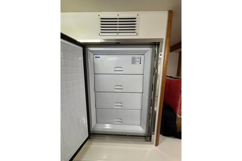 Slide: The Image of Open refrigerator with four drawers inside a 2020 Sabre 45 Salon Express yacht. - 74
