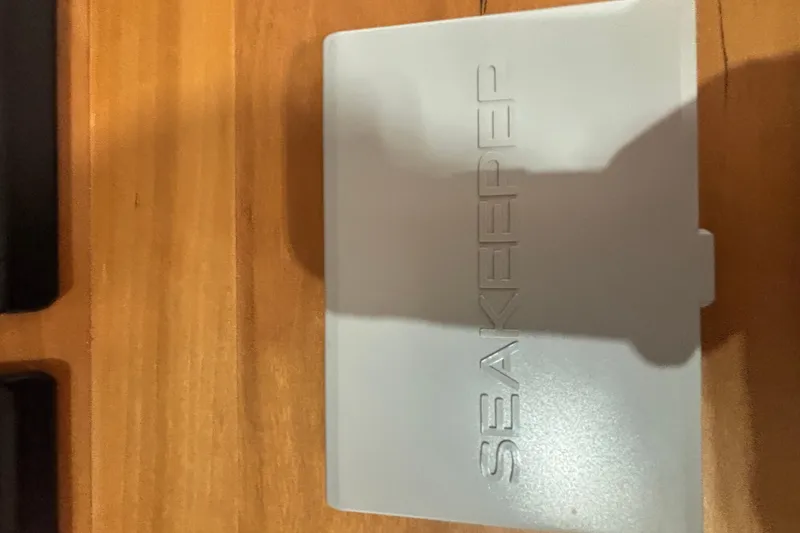 Slide: The Image of Seakeeper control panel on Sabre 45 Salon Express 2020, wooden surface background. - 76