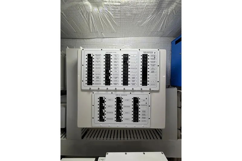 Slide: The Image of Electrical panel on 2020 Sabre 45 Salon Express yacht, featuring circuit breakers. - 84