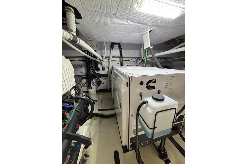 Slide: The Image of Engine room of 2020 Sabre 45 Salon Express with Cummins generator and piping. - 88