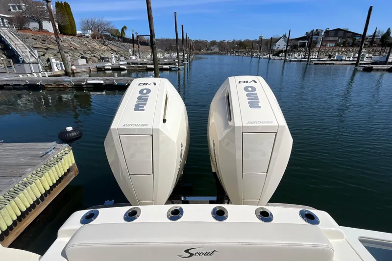 Slide: The Image of 2025 Scout 330 LXF boat with twin Mercury 350 engines docked in a marina. - 10