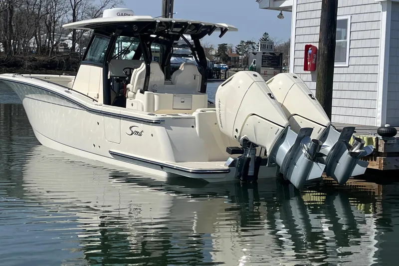 Slide: The Image of 2025 Scout 330 LXF boat docked with dual outboard engines. - 3