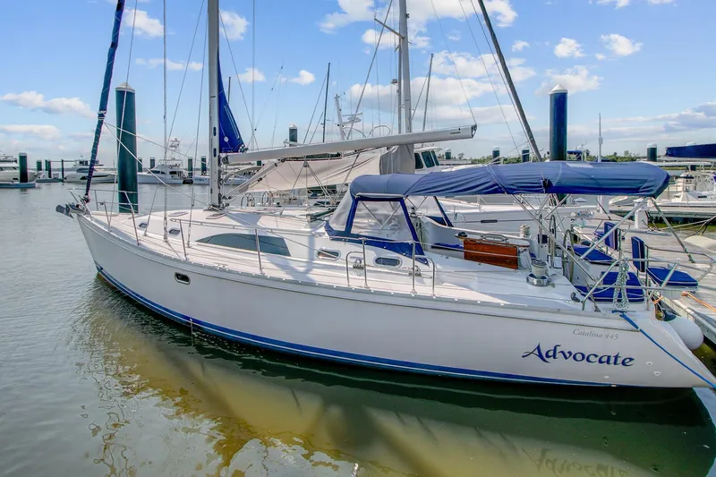 The Image of 2011 Catalina 445 sailboat docked in marina under blue sky. - 0