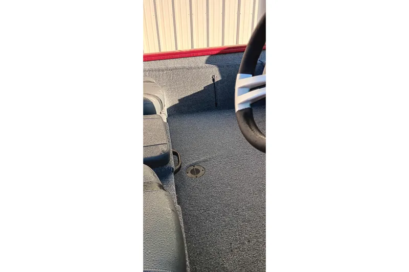 Slide: The Image of Interior view of 2025 Tracker Pro Team 190 boat, featuring steering wheel and seating. - 11