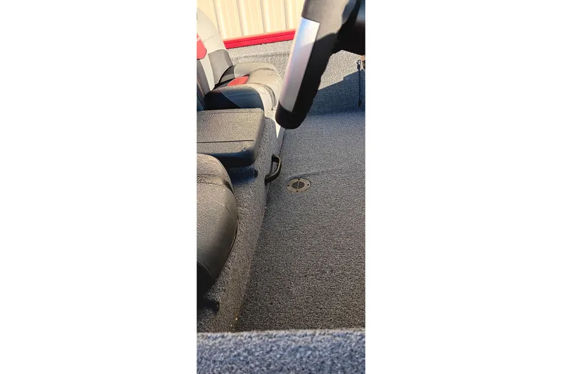 Slide: The Image of Interior view of 2025 Tracker Pro Team 190 boat, featuring seating and carpeted flooring. - 12