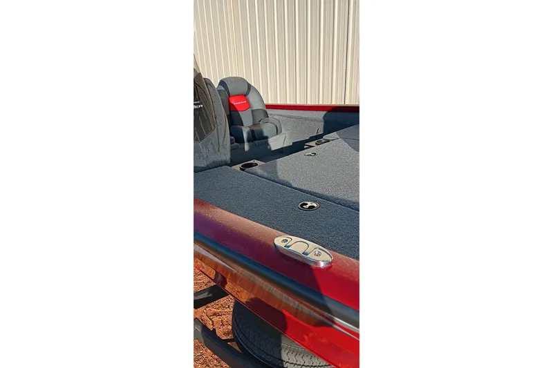 Slide: The Image of 2025 Tracker Pro Team 190 boat interior with gray carpet and seating. - 14