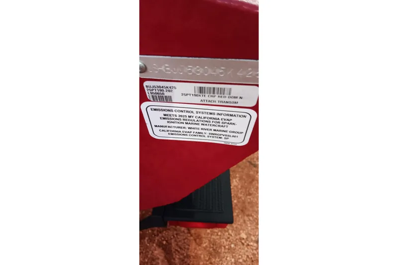 Slide: The Image of 2025 Tracker Pro Team 190 emissions control label on red surface. - 24