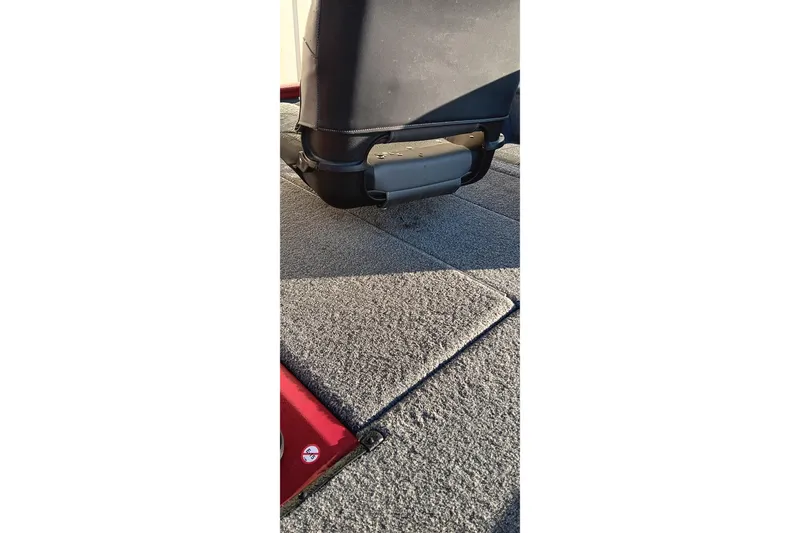 Slide: The Image of 2025 Tracker Pro Team 190 boat interior with carpeted flooring and seat base. - 9