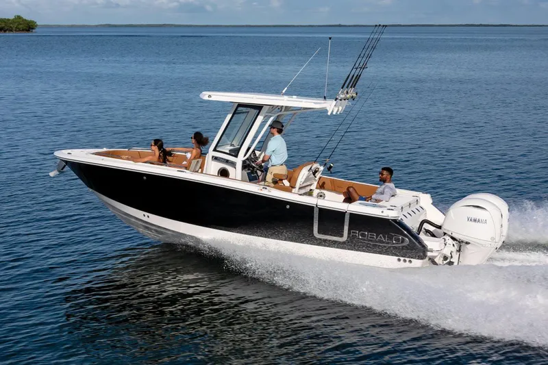 Slide: The Image of Manufacturer Provided Image: 2025 Robalo R250 Center Console boat cruising on open water with passengers. - 2