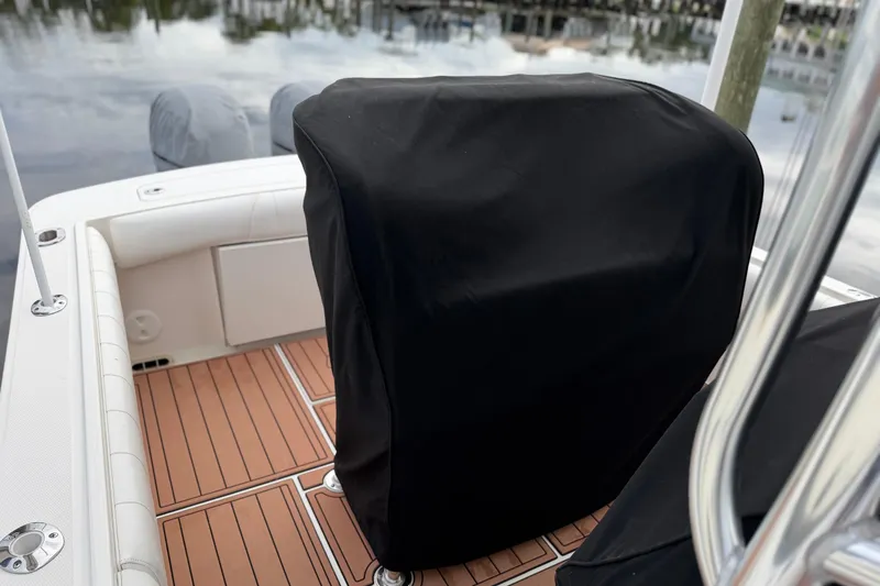 Slide: The Image of 2015 Regulator 25 boat cruising on open water with twin Yamaha engines. - 1