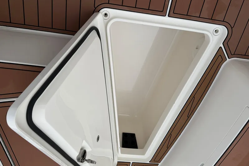 Slide: The Image of 2015 Regulator 25 boat seat with black protective cover on deck. - 12