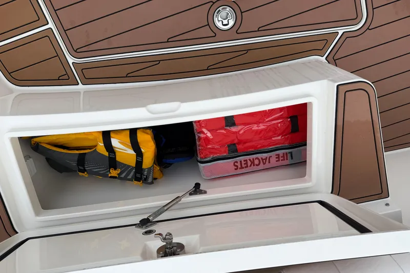 Slide: The Image of 2015 Regulator 25 boat interior with white seating and steering wheel. - 14