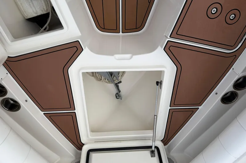 Slide: The Image of 2015 Regulator 25 boat docked at marina under blue sky. - 15