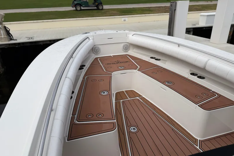 Slide: The Image of 2015 Regulator 25 boat cruising on open water, creating a wake. - 3