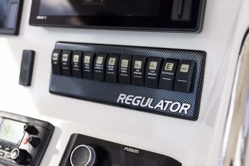 Slide: The Image of Control panel of a 2015 Regulator 25 boat with labeled switches and electronics. - 30